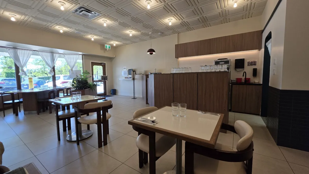 Restaurant interior with tables, chairs, and counter